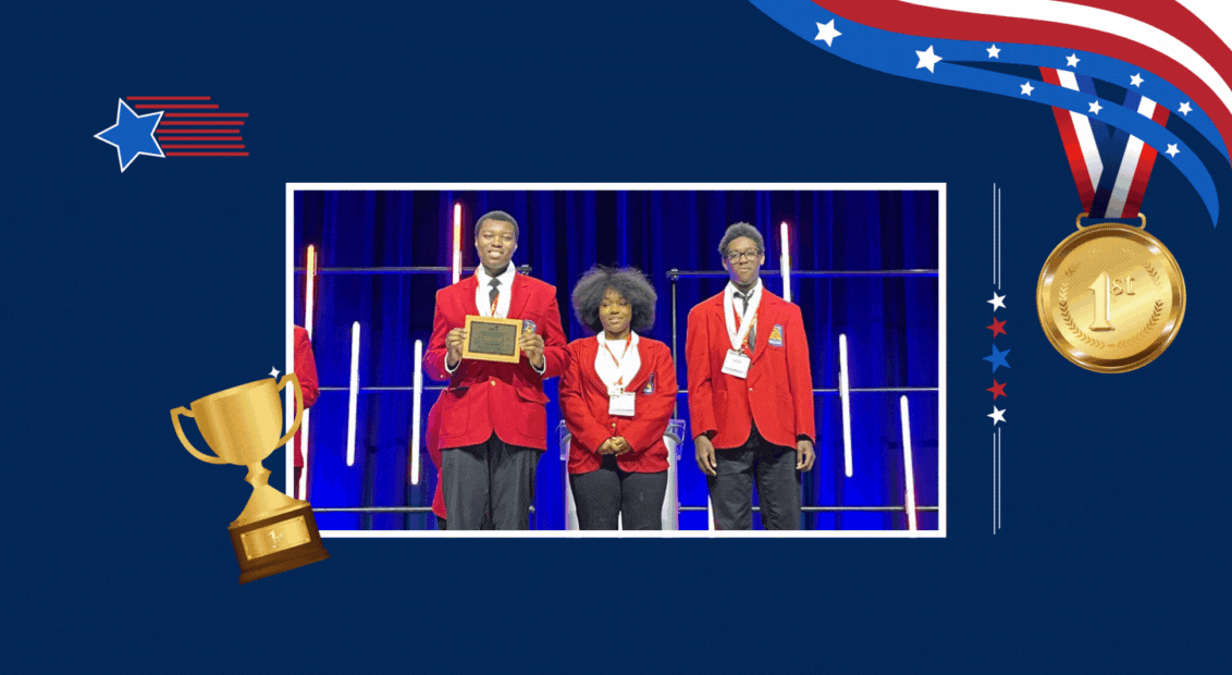  3 students smiling holding a plaque